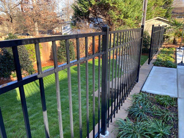 Landscaped yard with iron fence